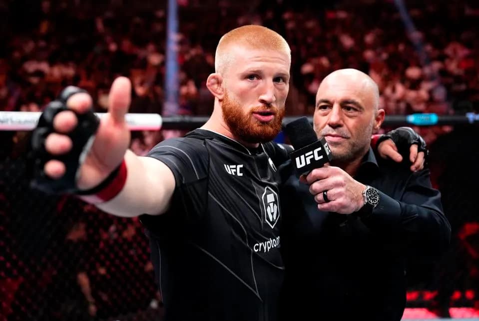 Bo Nickal giving a speech after winning a bout, with Joe Rogan.